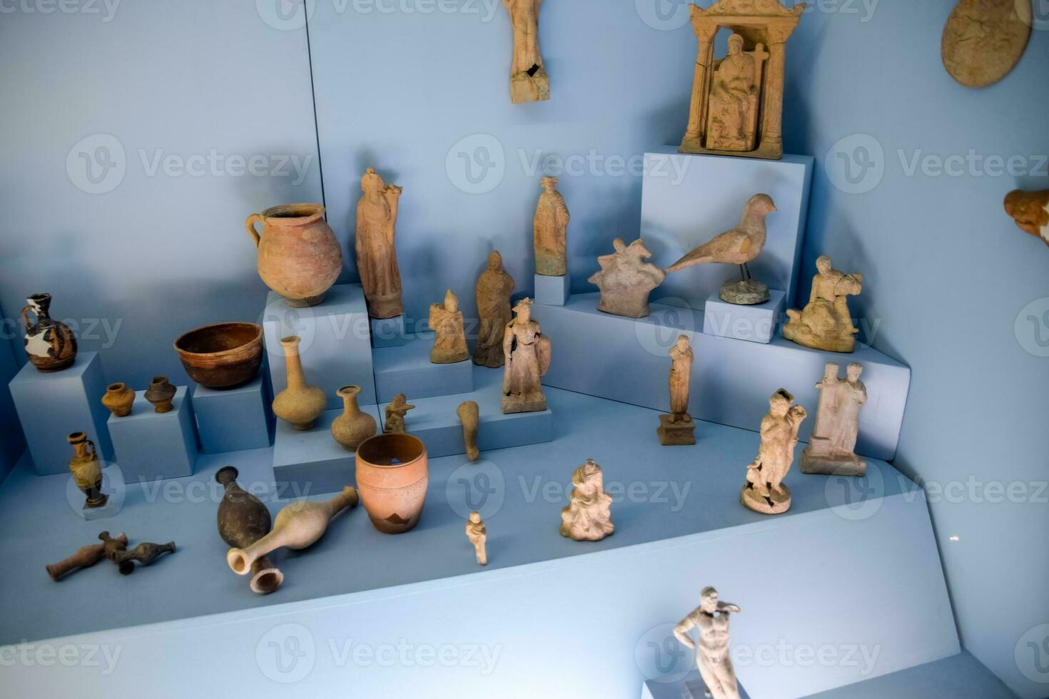 Clay and metal dishes and clay figurines and figurines in the museum of antiquity of Antalya. photo