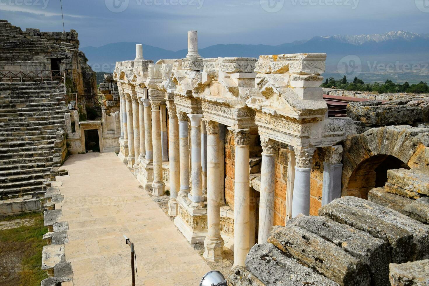 Columns on the stage of the amphitheater. Ancient antique amphitheater in city of Hierapolis in Turkey. photo