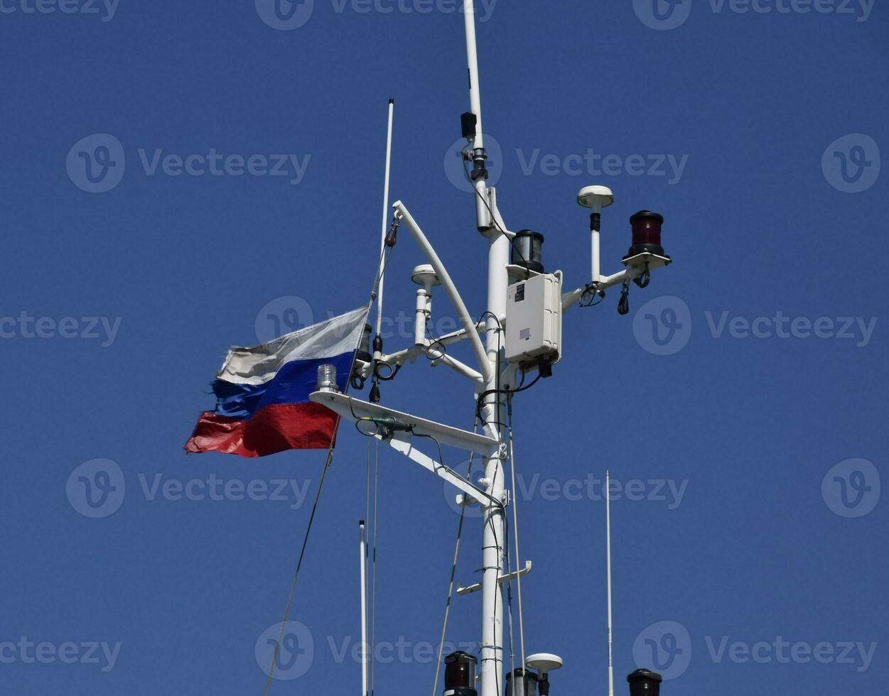 Mast of the port service ship. Devices of light signaling and communication antenna. photo