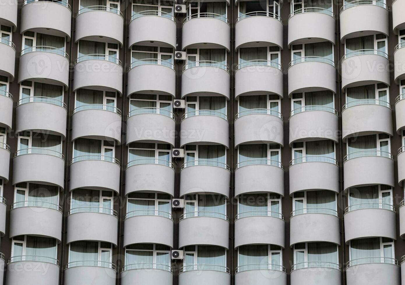 Background texture of balconies and windows of hotel. The wall of the hotel with balconies and windows. photo