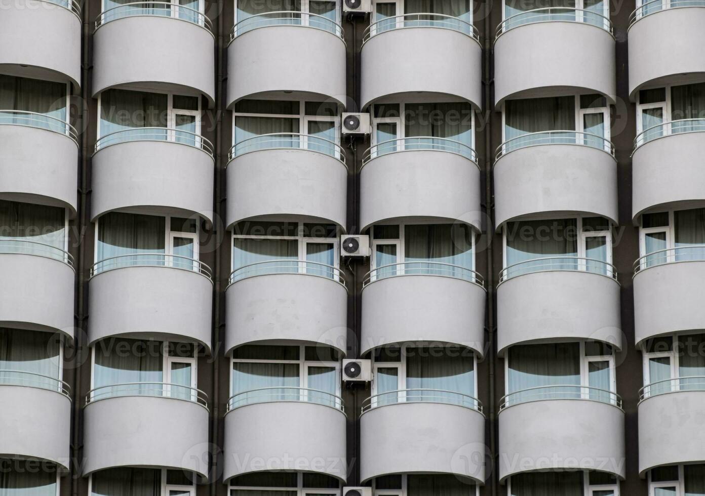 Background texture of balconies and windows of hotel. The wall of the hotel with balconies and windows. photo