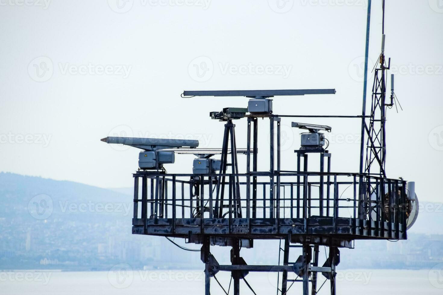 Rotating antennas of a military radio station on tower. photo