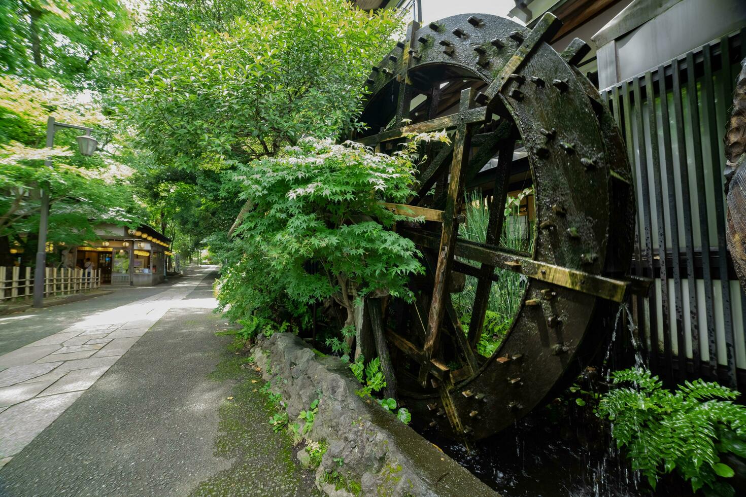 A historic wooden wheel on the water surface in Tokyo wide shot photo