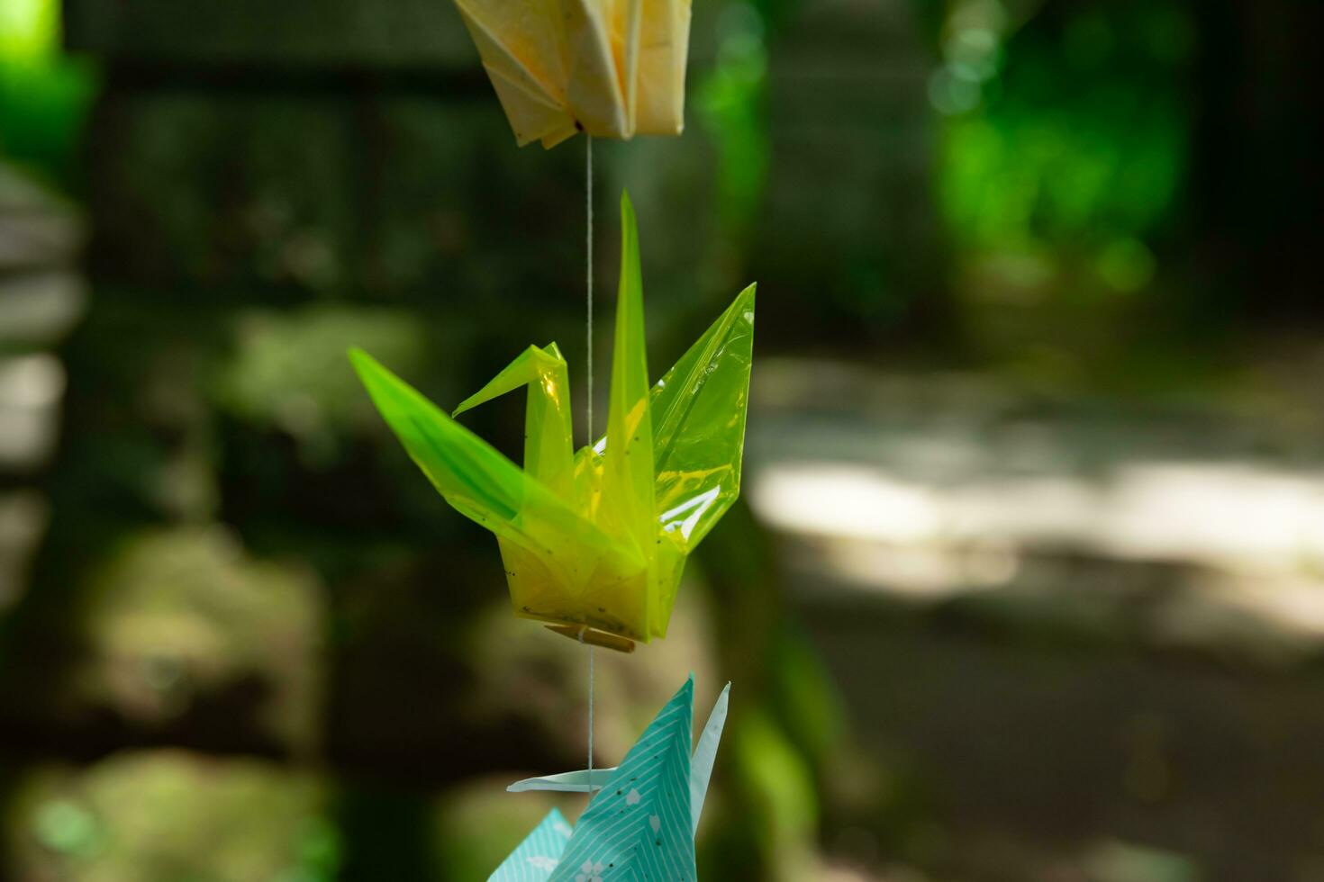 A paper crane swaying in the wind at the traditional street close up photo