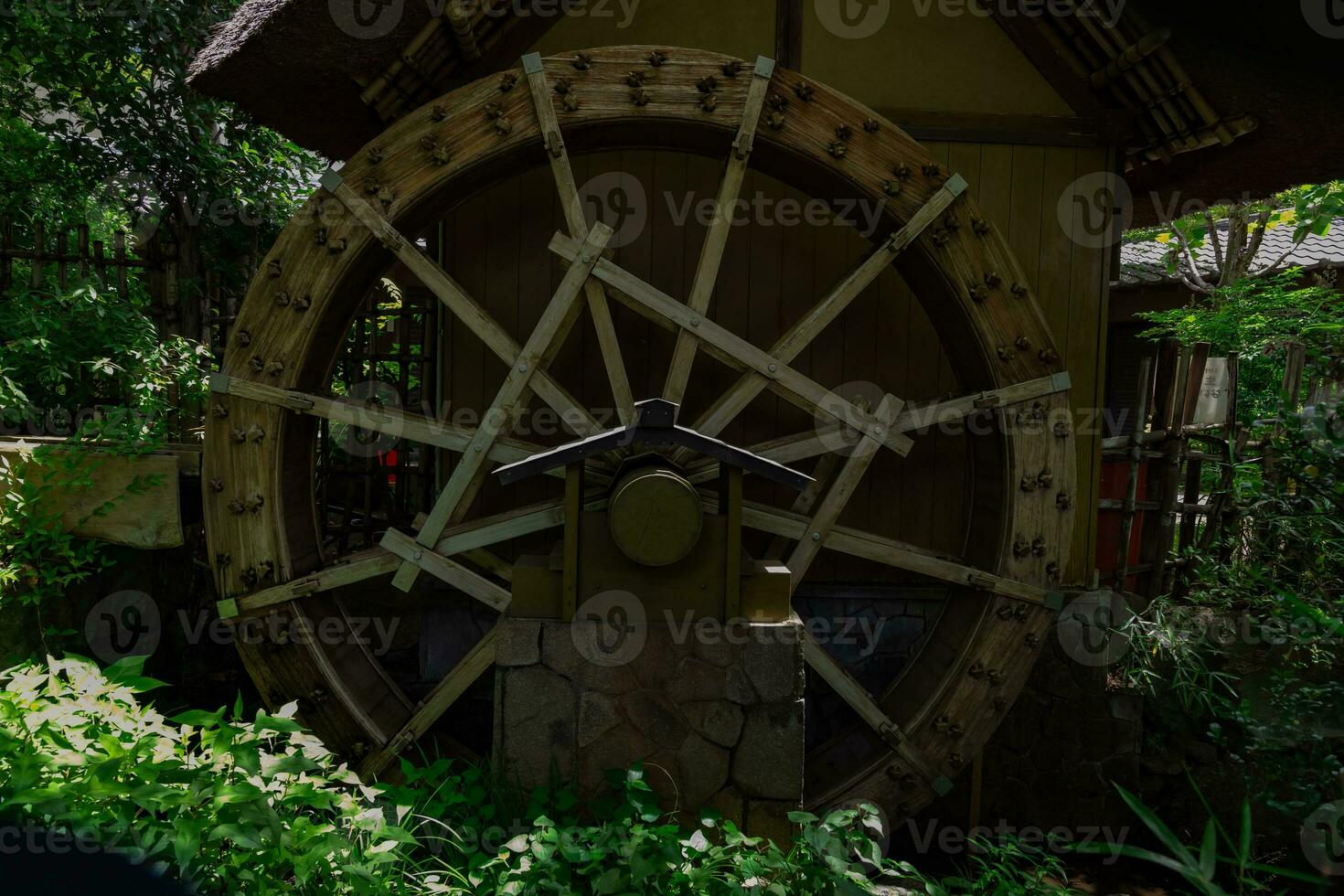 A historic wooden wheel on the water surface in Tokyo photo