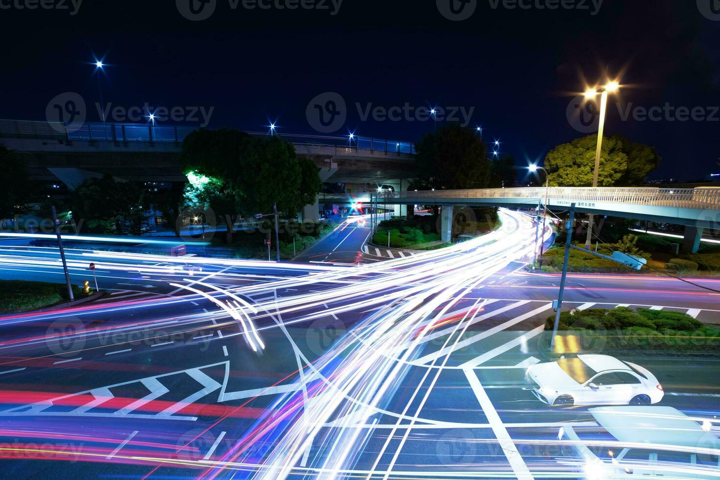 A night timelapse of traffic jam at the city intersection in Tokyo wide shot photo