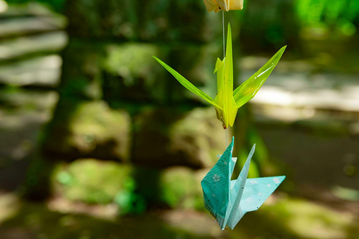 A paper crane swaying in the wind at the traditional street close up photo