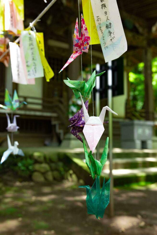 A paper crane swaying in the wind at the traditional street photo