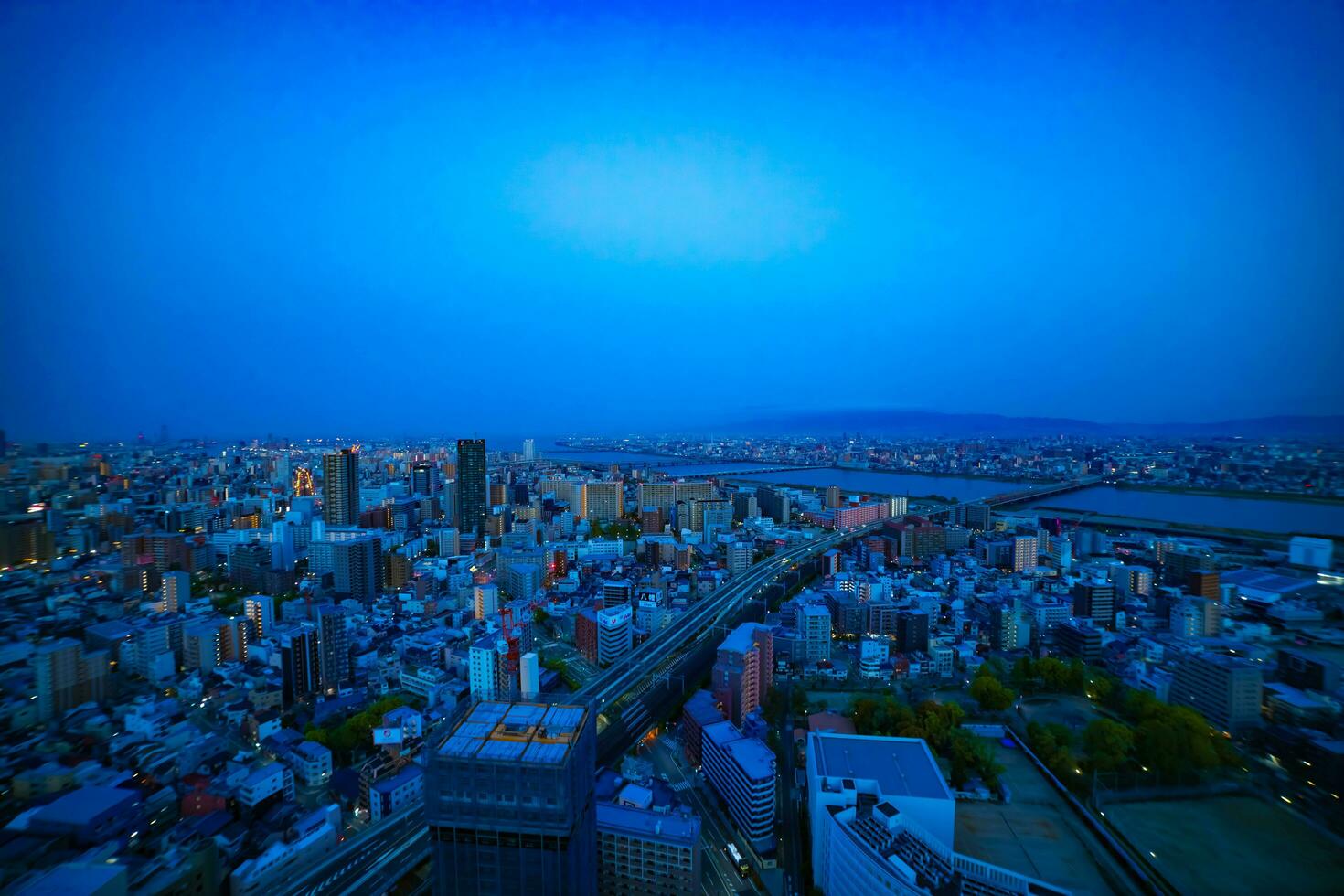A dawn panoramic cityscape near Yodo river in Osaka wide shot photo