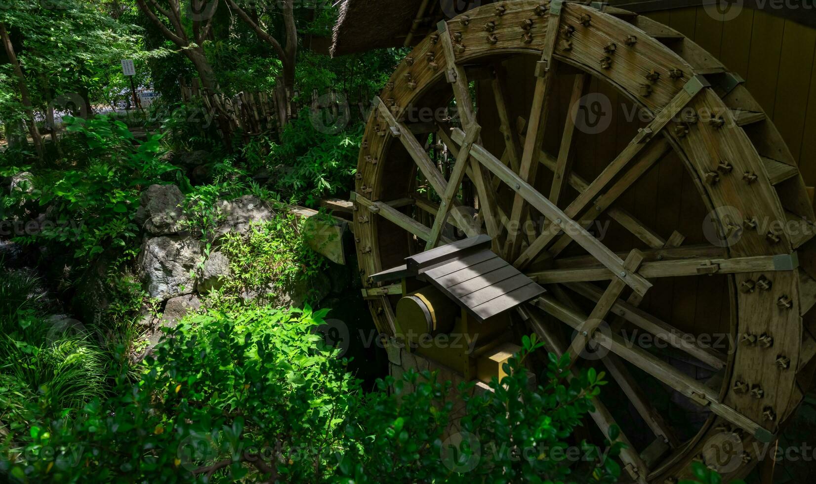 A historic wooden wheel on the water surface in Tokyo photo