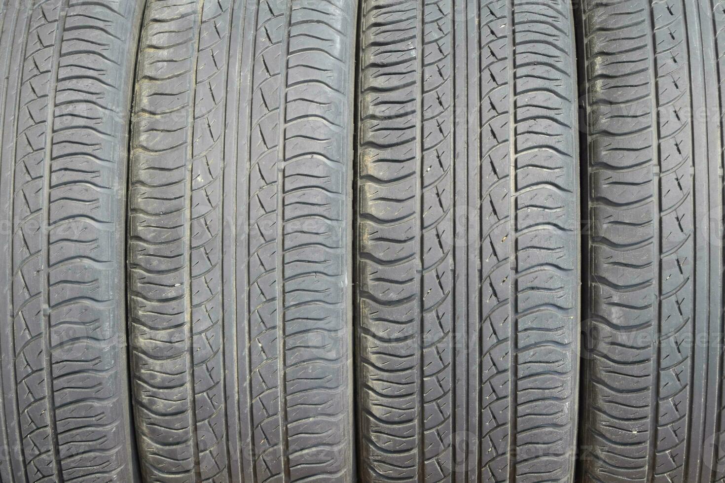 The background of the tread pattern of the car wheel. Rubber tir photo