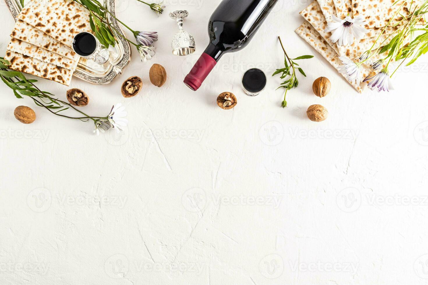 Festive background for the Jewish holiday Passover. Traditional treats, bottle of wine, matza on white background. Top view. A copy space. border photo