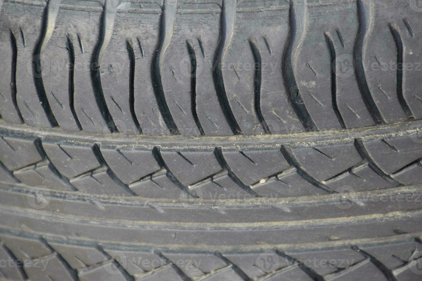 The background of the tread pattern of the car wheel. Rubber tir photo