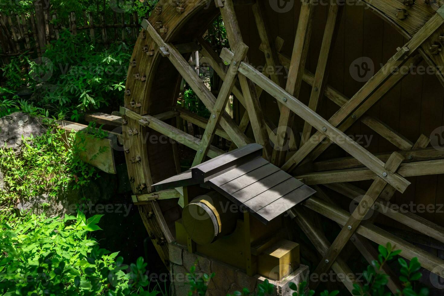 A historic wooden wheel on the water surface in Tokyo photo