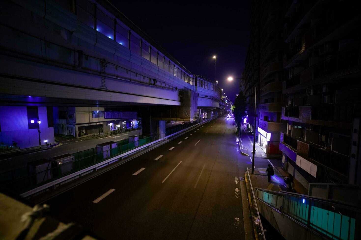 A night timelapse of the traffic jam at the city street under the highway wide shot photo