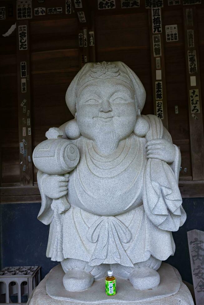 A Japanese gardian statue at the traditional street in Tokyo photo