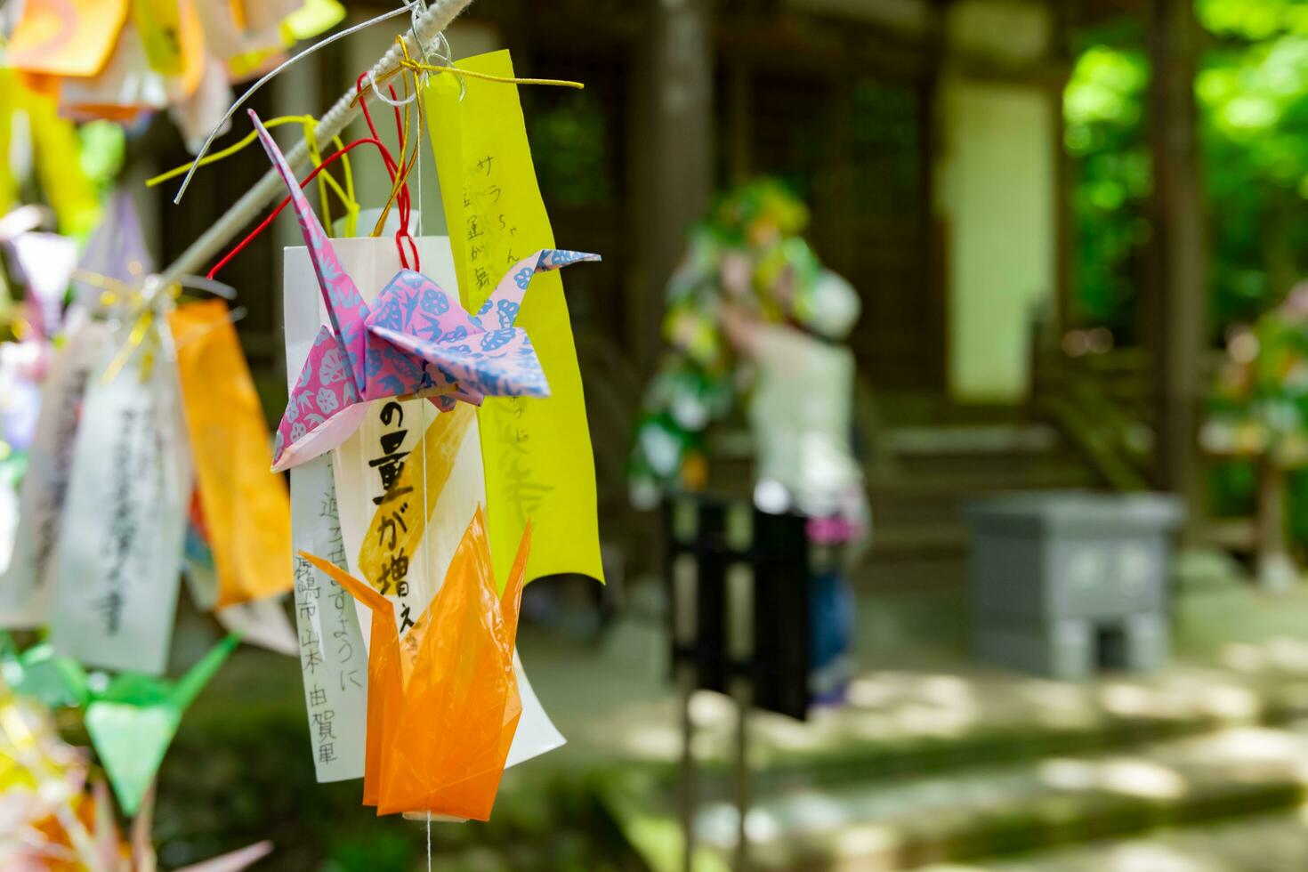 A paper crane swaying in the wind at the traditional street close up photo
