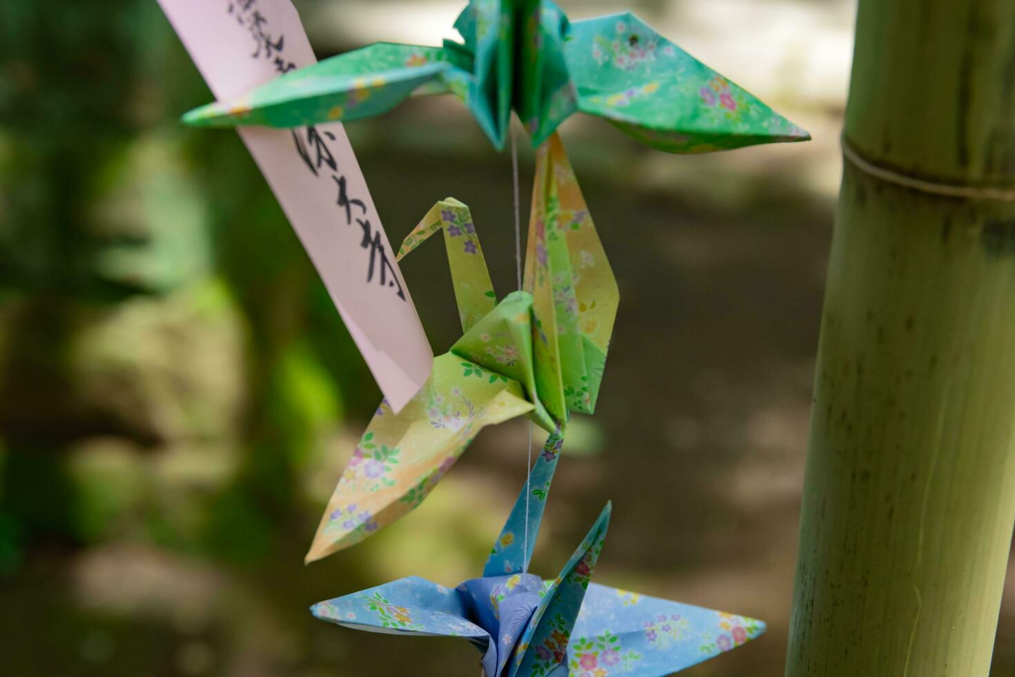 A paper crane swaying in the wind at the traditional street close up photo