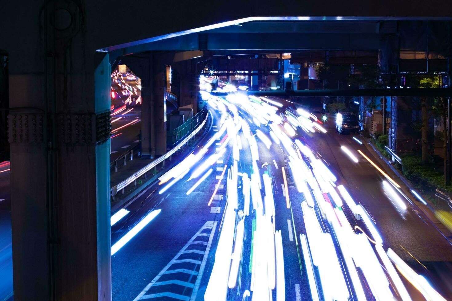 A night traffic jam at the city street under the highway in Tokyo photo