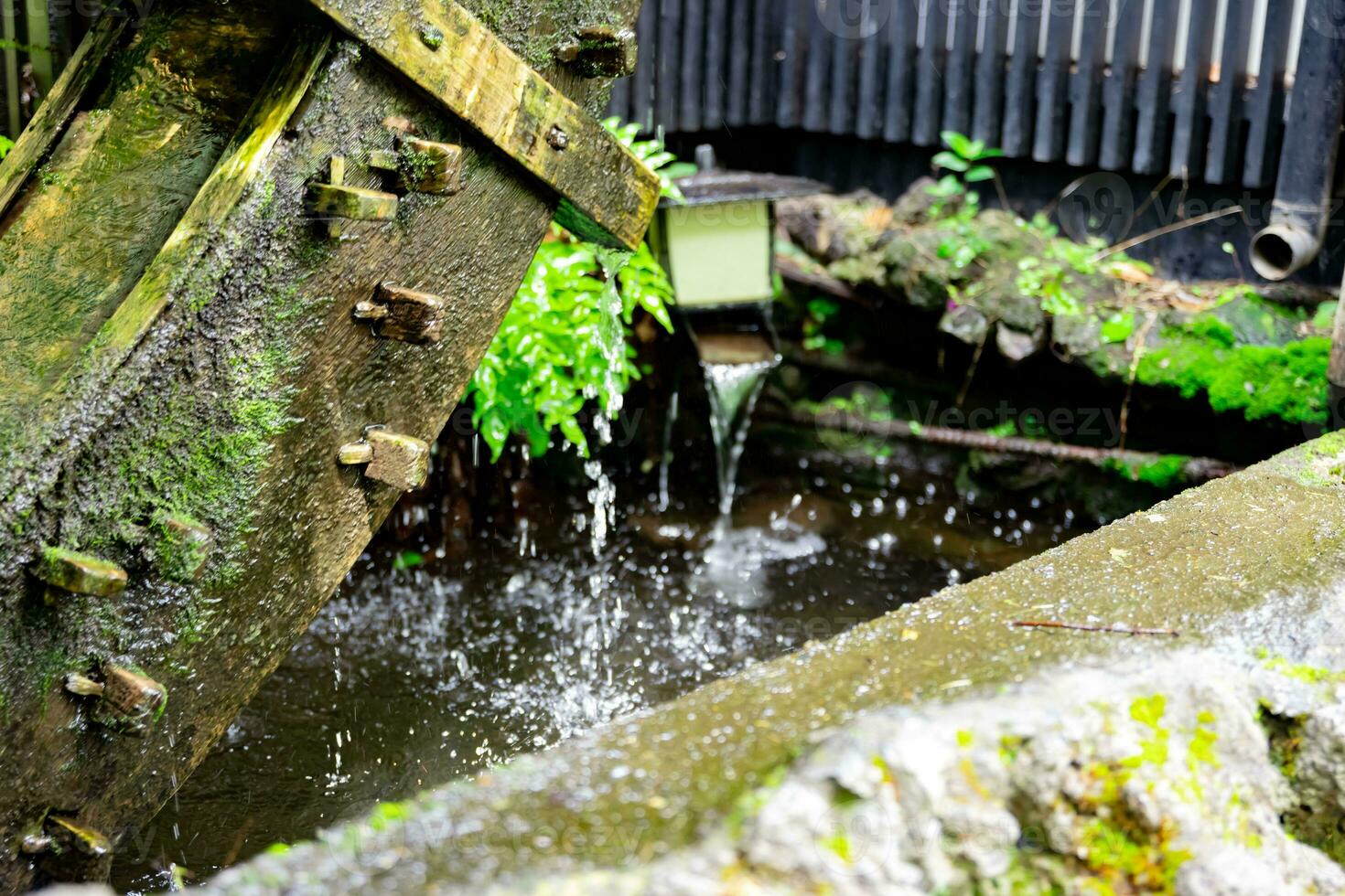 A historic wooden wheel on the water surface in Tokyo close up photo