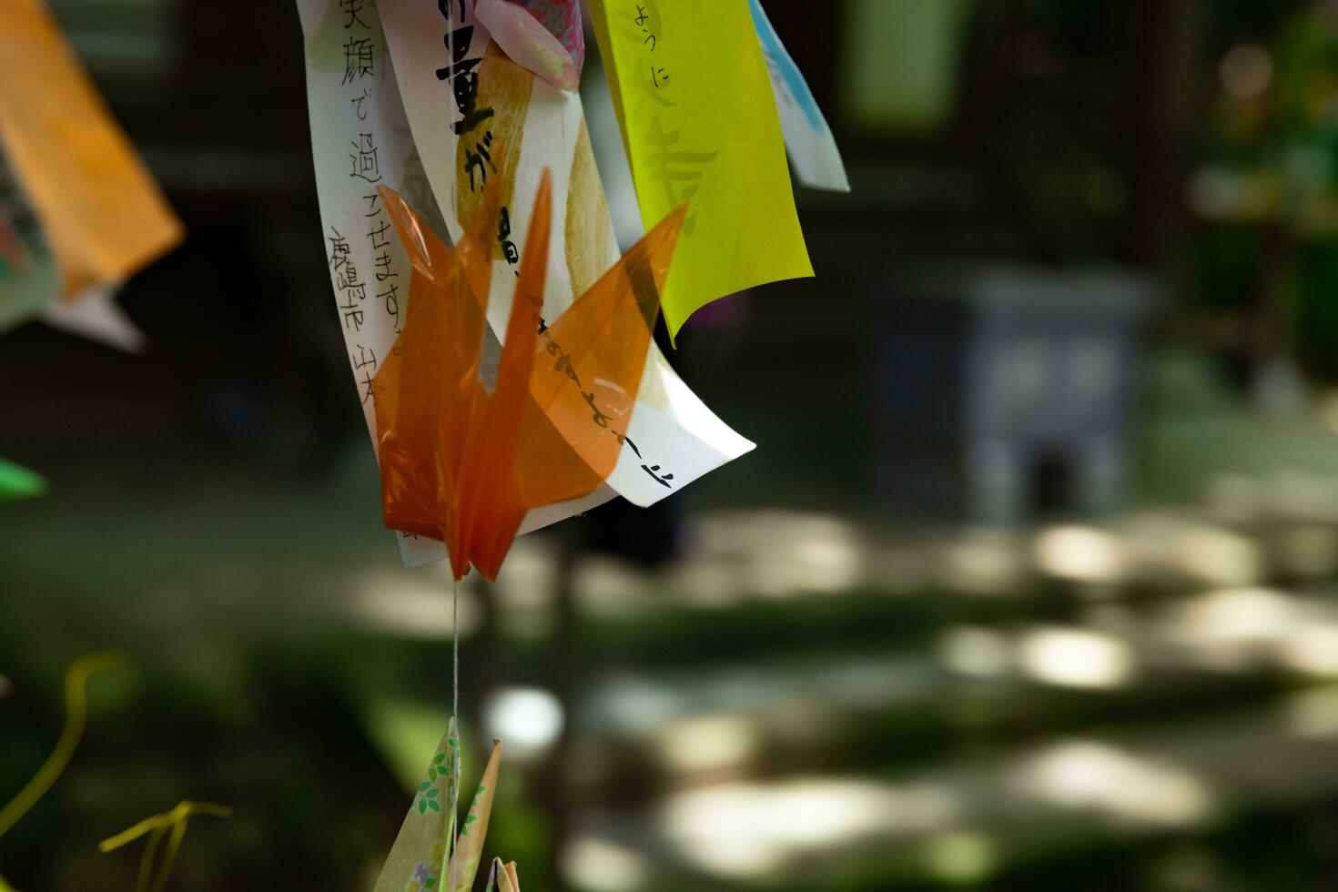 A paper crane swaying in the wind at the traditional street close up photo