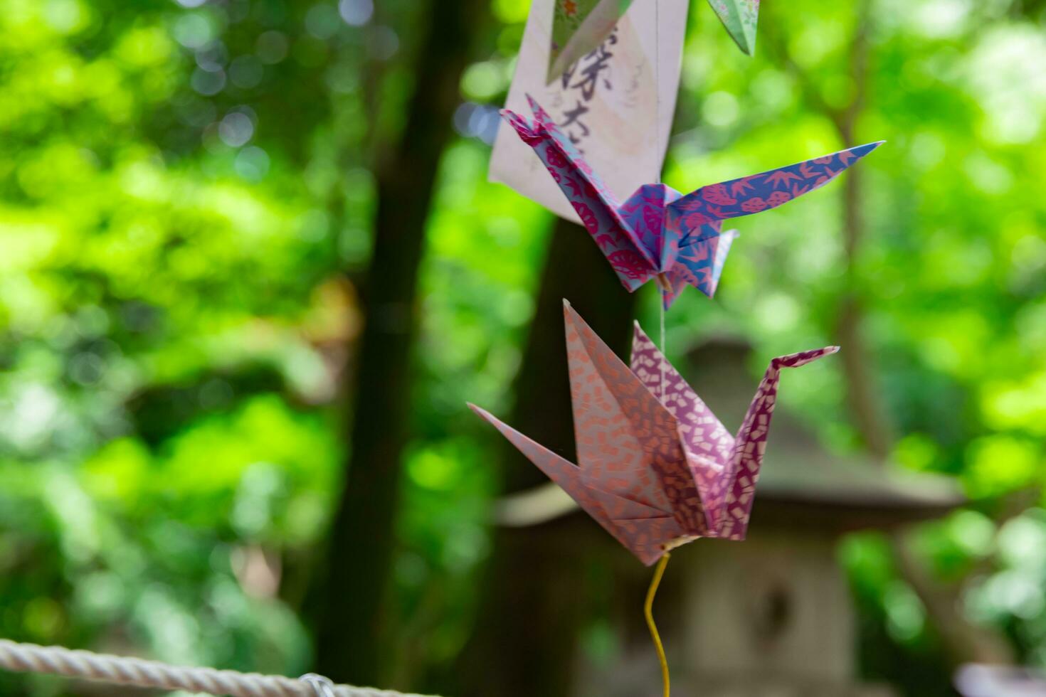 A paper crane swaying in the wind at the traditional street close up photo