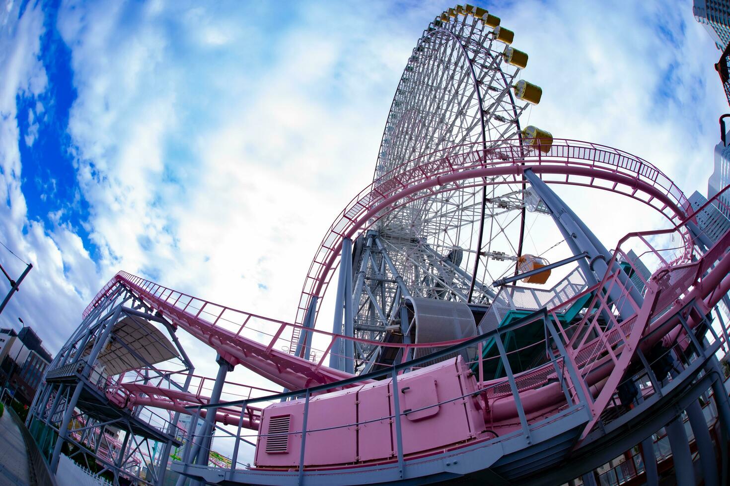 A ferris wheel behind the blue sky in Yokohama sunny day low angle photo