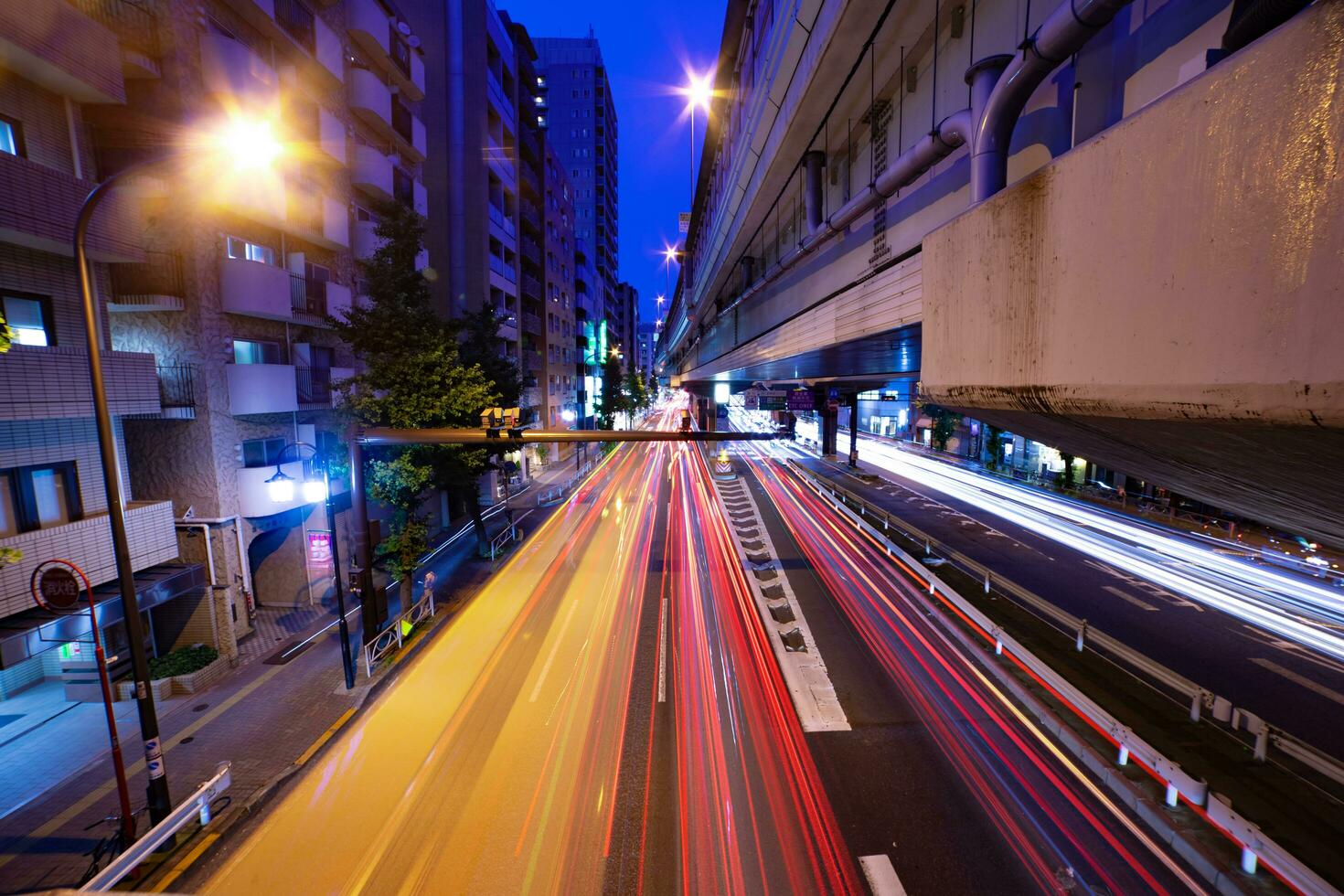 A night timelapse of the traffic jam at the city street under the highway wide shot photo