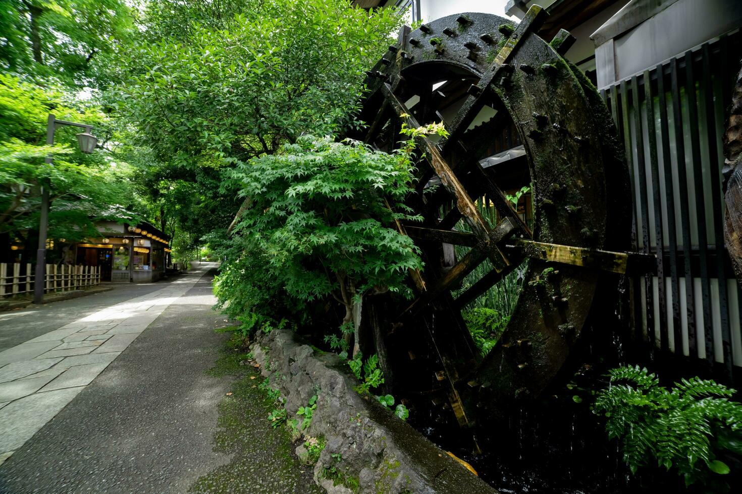 A historic wooden wheel on the water surface in Tokyo wide shot photo