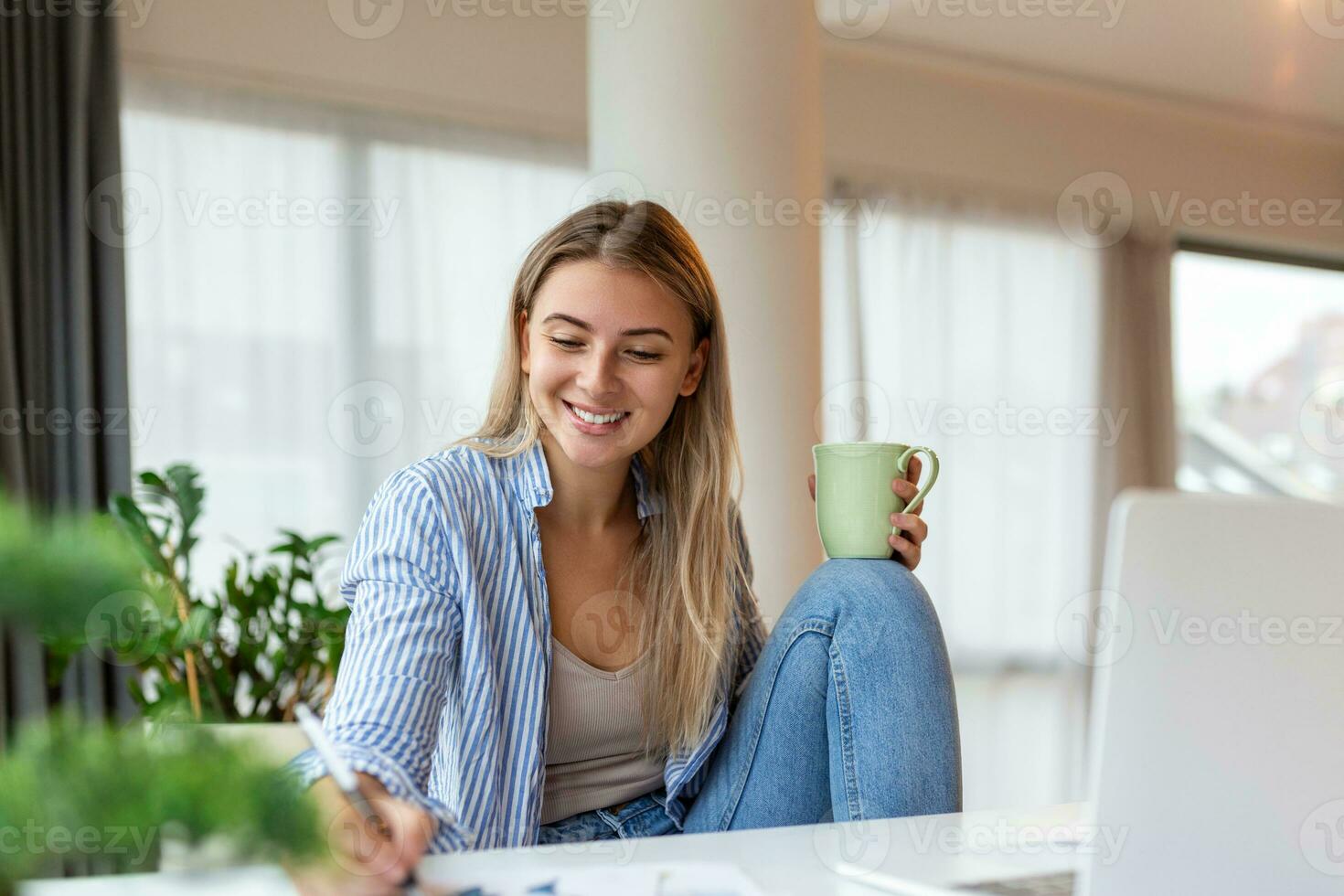 Young woman working laptop. Business woman busy working on laptop computer at office. Businesswoman sitting at bright modern work station and typing on laptop photo