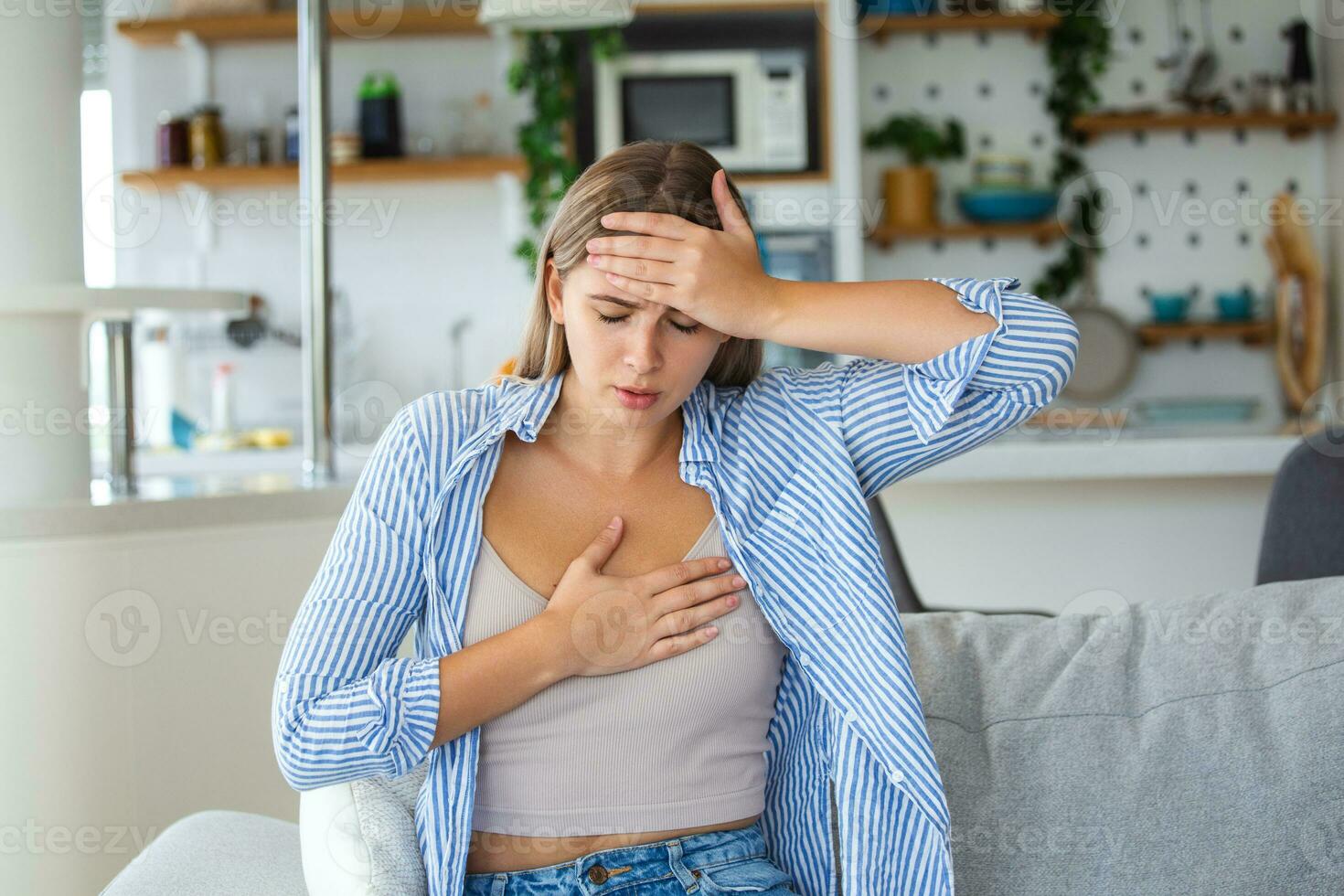 Breathing, respiratory problem, asthma attack, pressure, chest pain, sun stroke, dizziness concept. portrait of woman received heatstroke in hot summer weather, touching her forehead photo