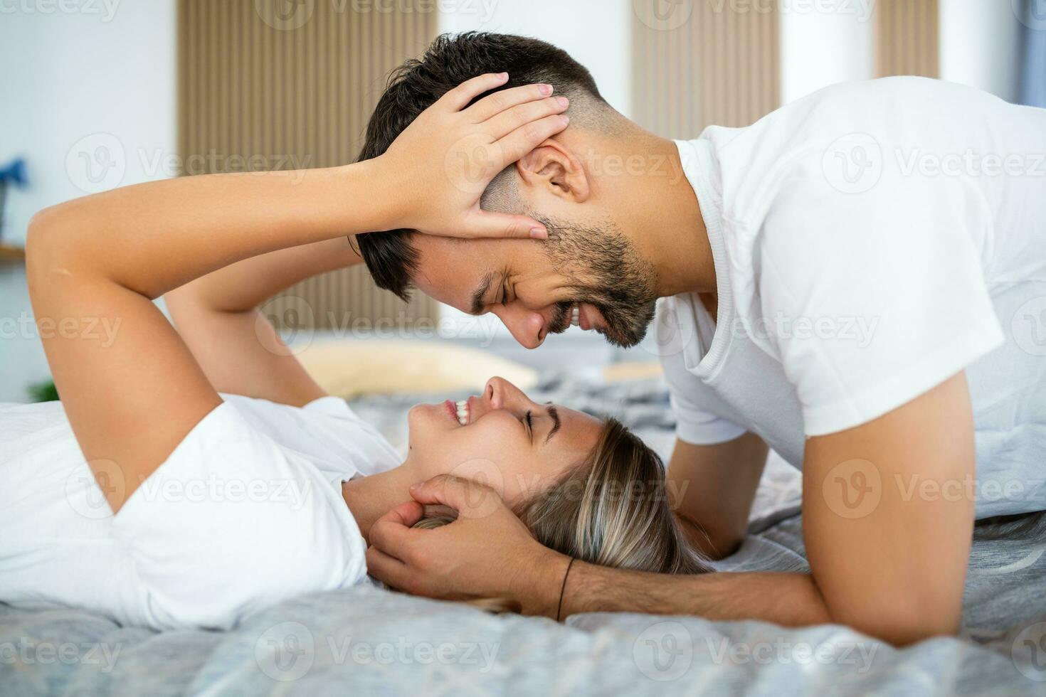Shot of an affectionate young couple sharing a romantic moment in the bedroom at home photo