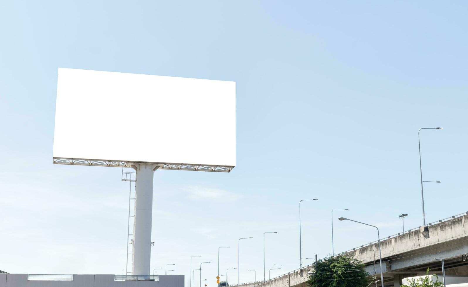 Pole outdoor billboard with blue sky background. Clipping path for mockup white screen photo