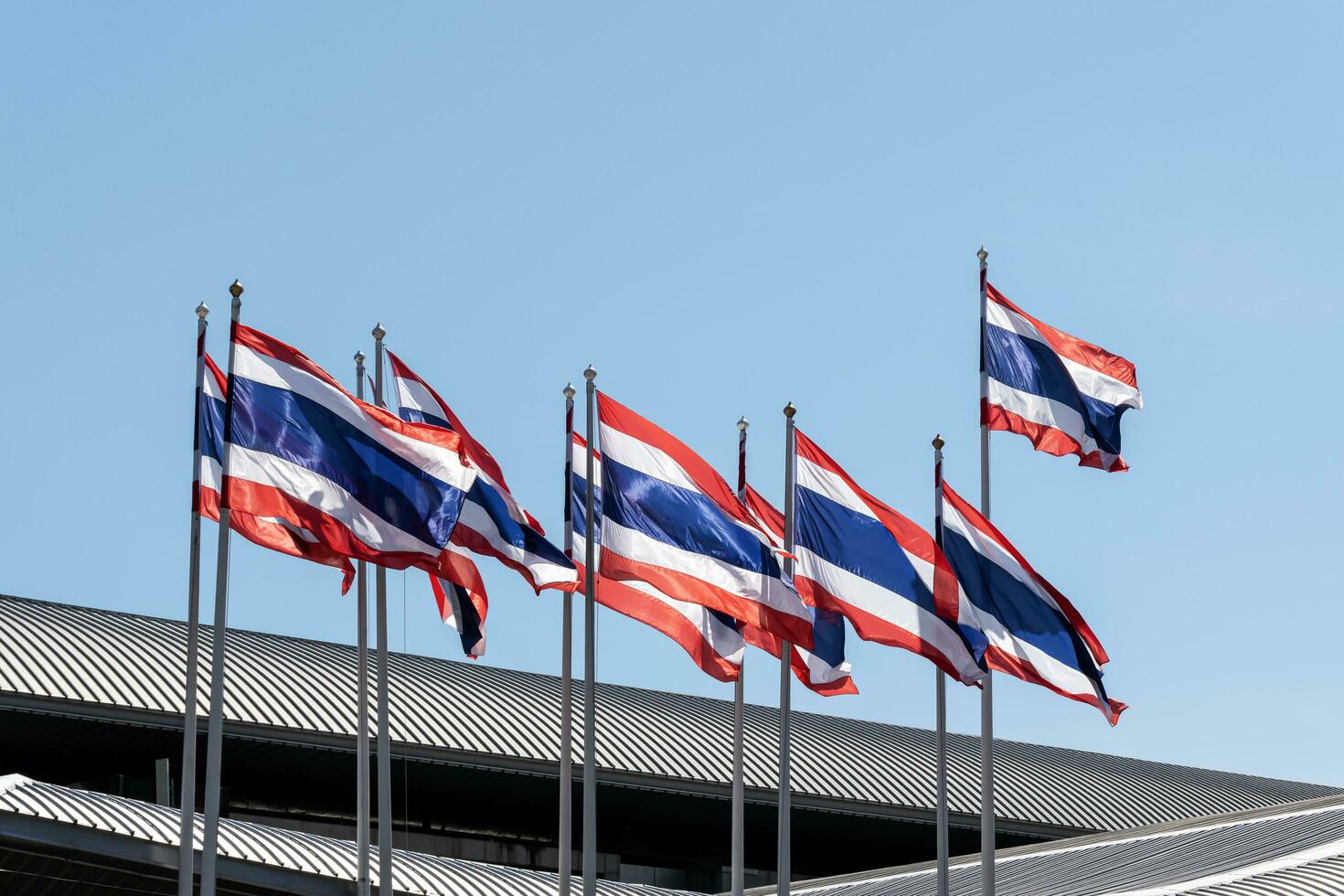 Thailand flag pole in front of building photo