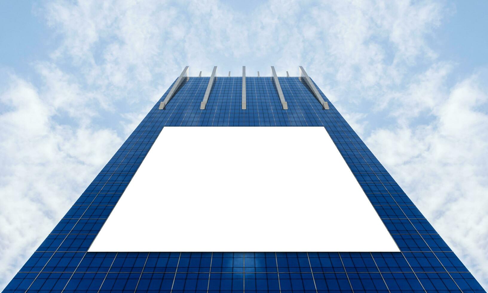 Bottom up view mock up LED display billboard on office building with blue sky background and clipping path for mock up photo