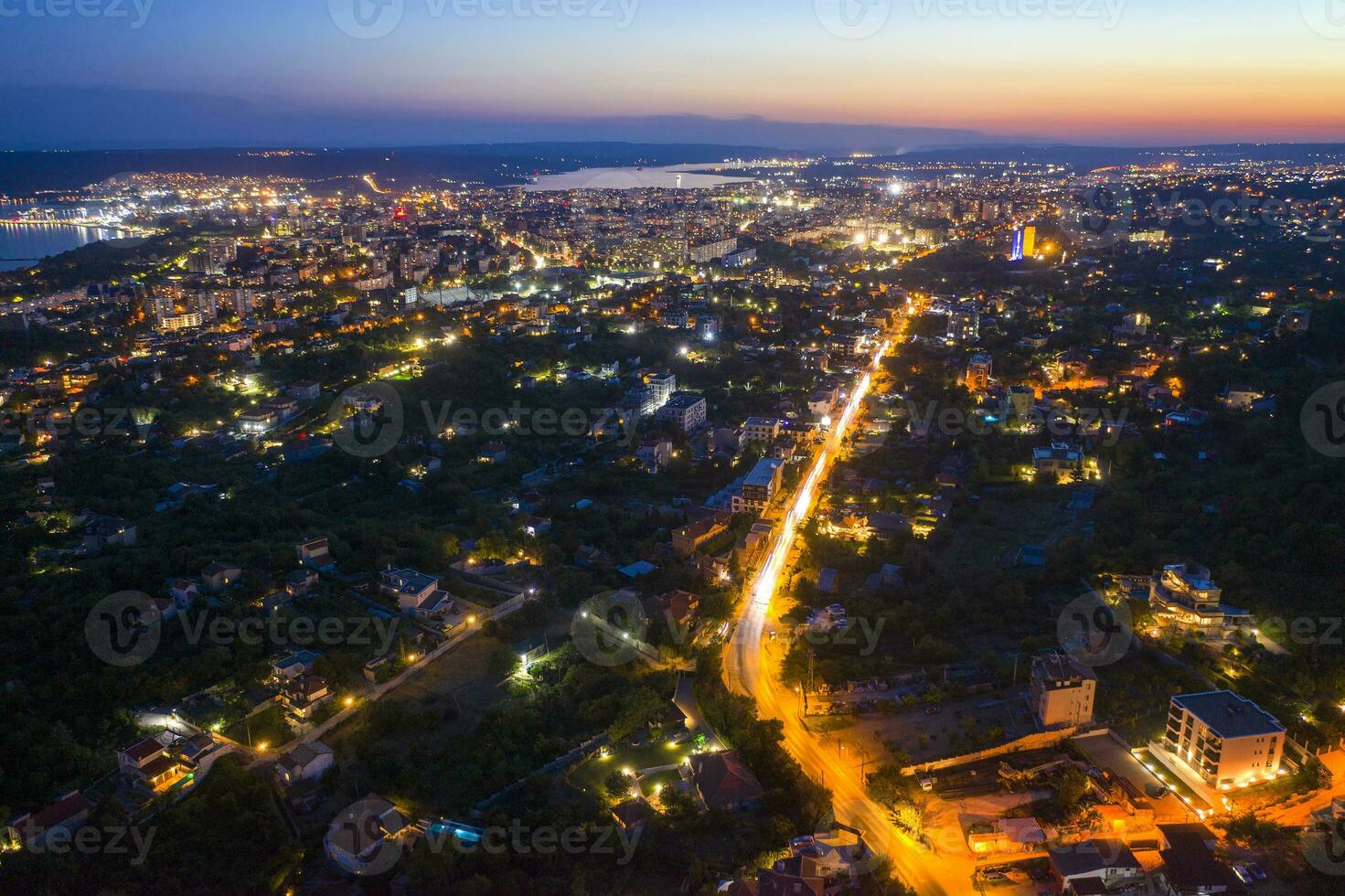 Aerial view from the drone of the illuminated city at twilight. Varna, Bulgaria photo