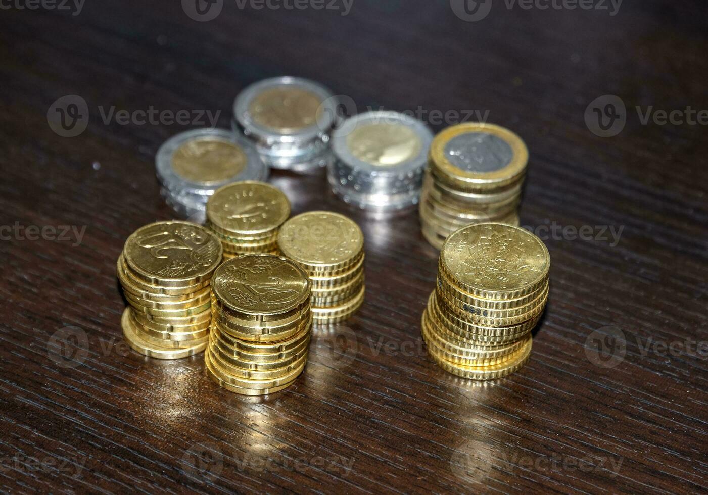 Piles of coins on the table, lev, and euro for traveling photo