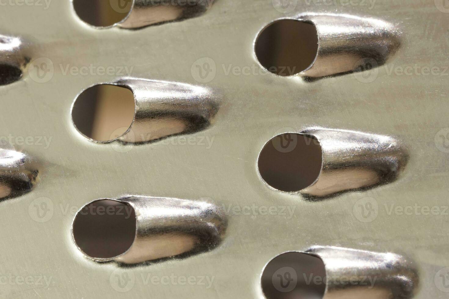 Vegetable slicer surface. Grater abstract close-up macro shot for background. photo