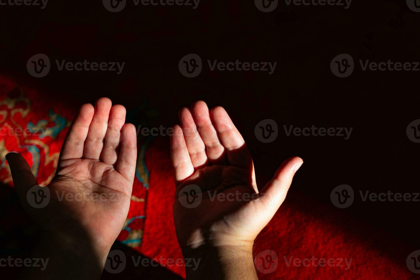 Islamic praying background photo. Muslim man praying with raising hands. photo