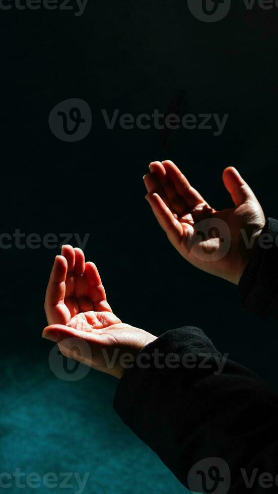 Islamic background photo. Muslim man praying with raising hands. photo