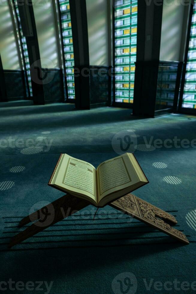 Ramadan or islamic vertical concept photo. The Holy Quran on the book stand photo