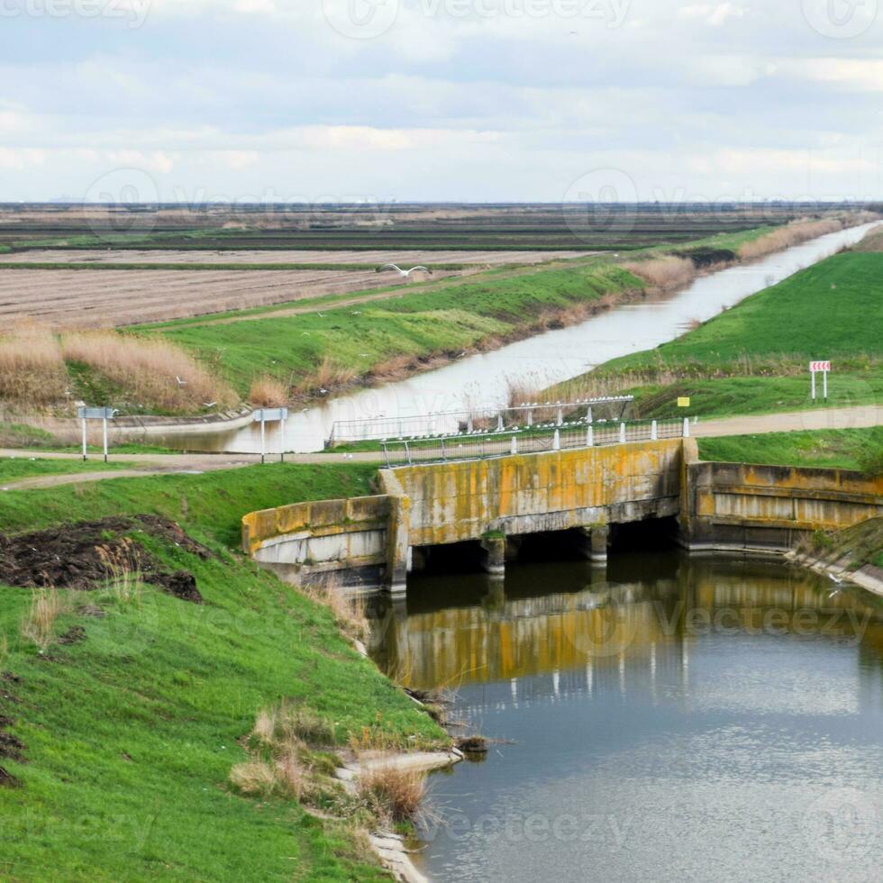 Bridges through irrigation canals. Rice field irrigation system photo