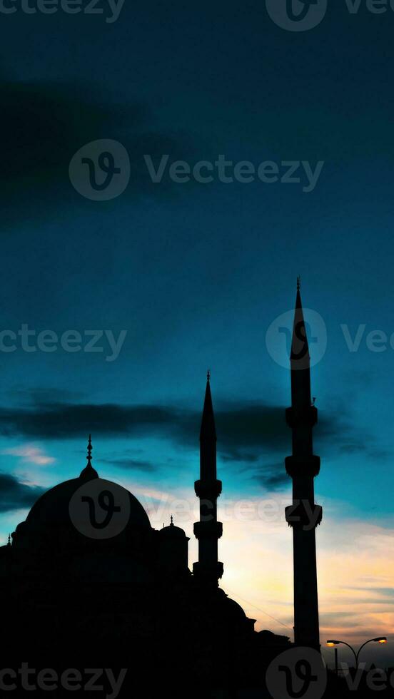 Eminonu Yeni Cami or New Mosque at sunset. Islamic concept vertical photo