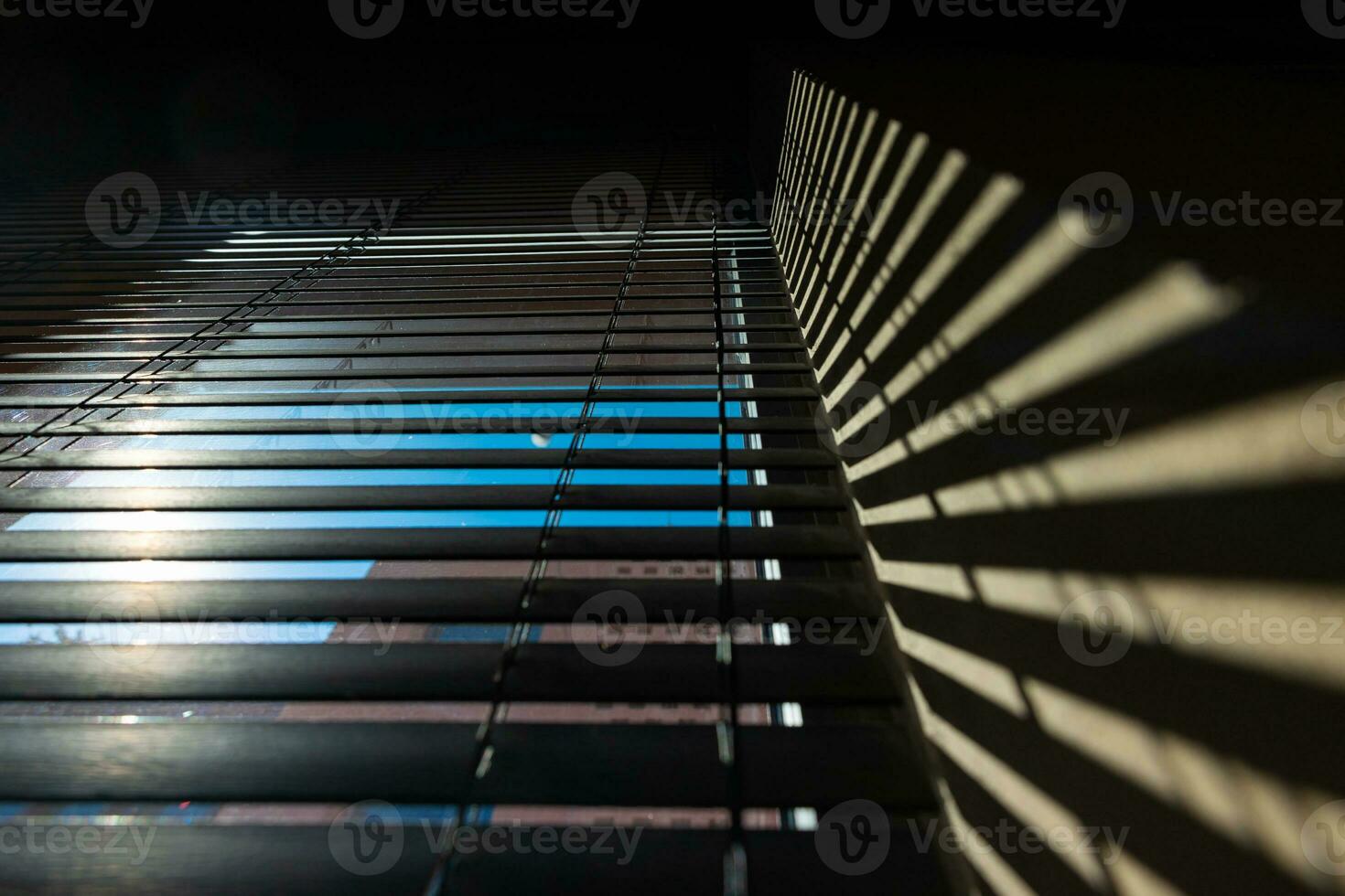 Office or window blinds or jalousies with shadows on the wall. photo