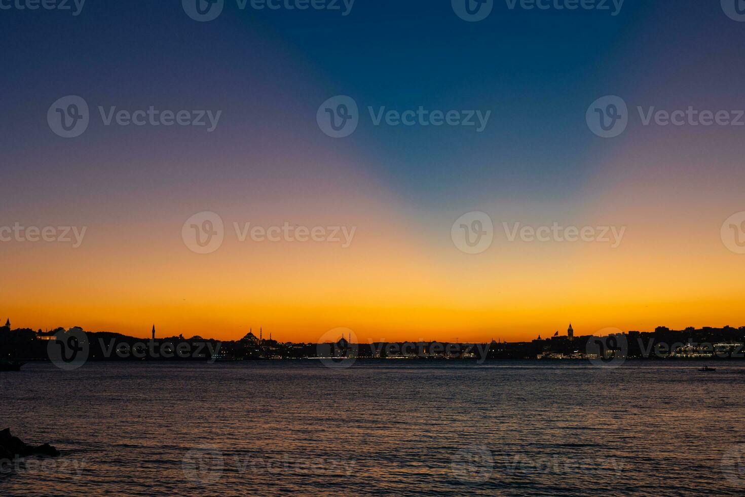 Istanbul skyline with crepuscular rays on the sky. photo