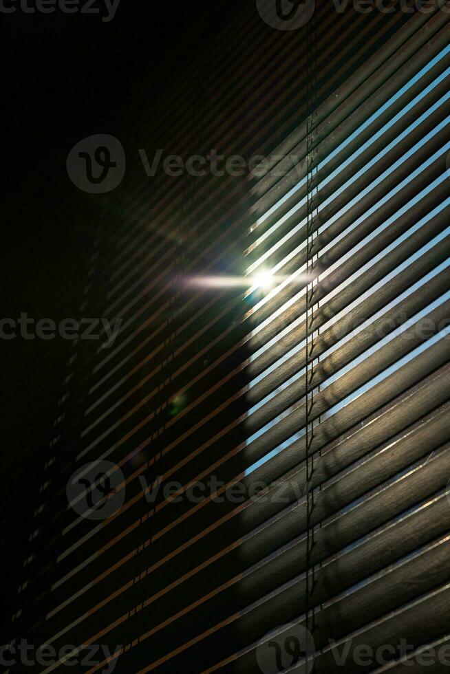 Window blinds or jalousies with a little sunshine. Interior architecture photo