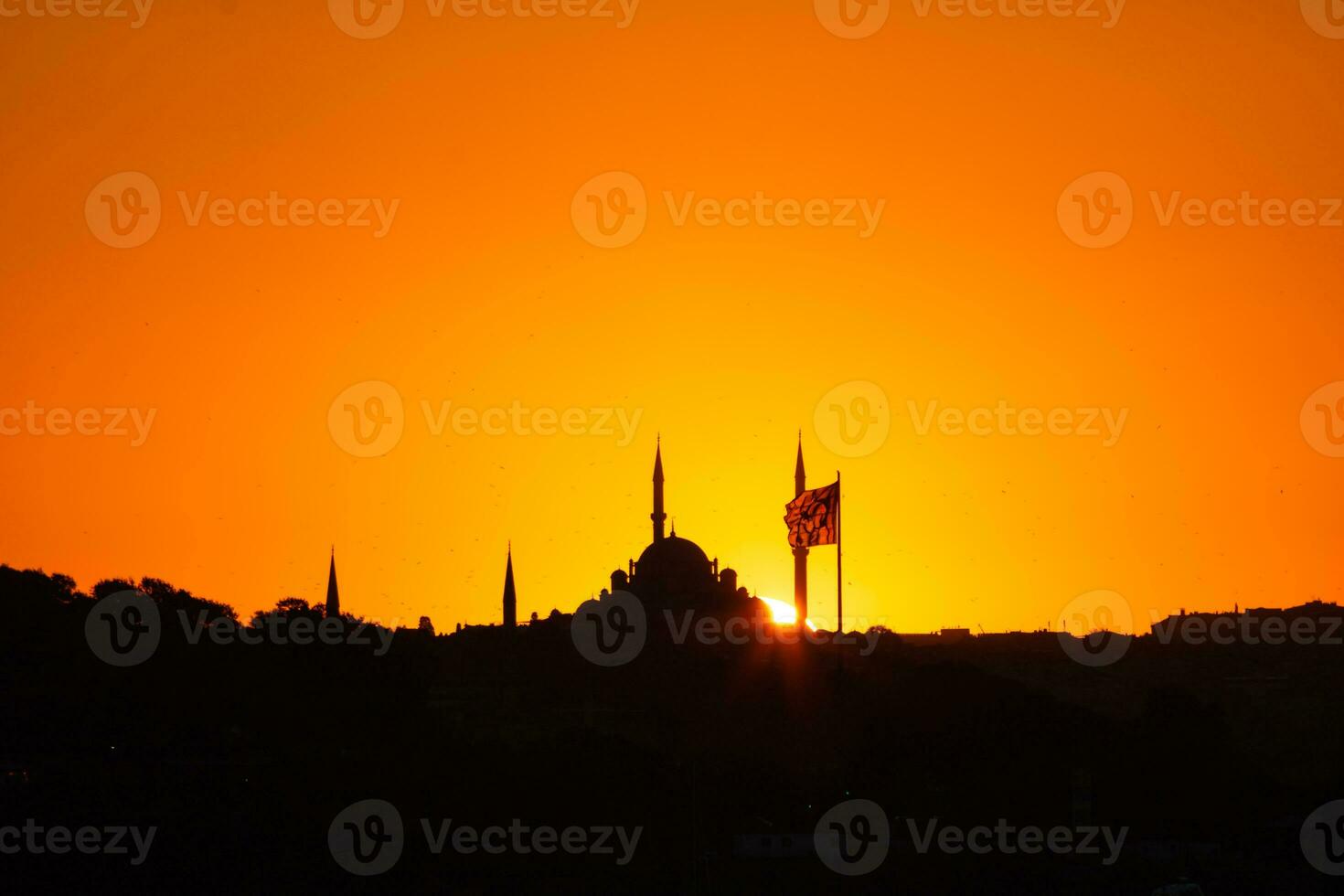 Fatih Mosque silhouette at sunset with Flag of Turkiye photo