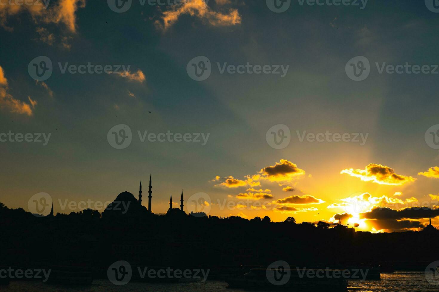Istanbul silhouette. Sunlight rays and Suleymaniye Mosque at sunset photo