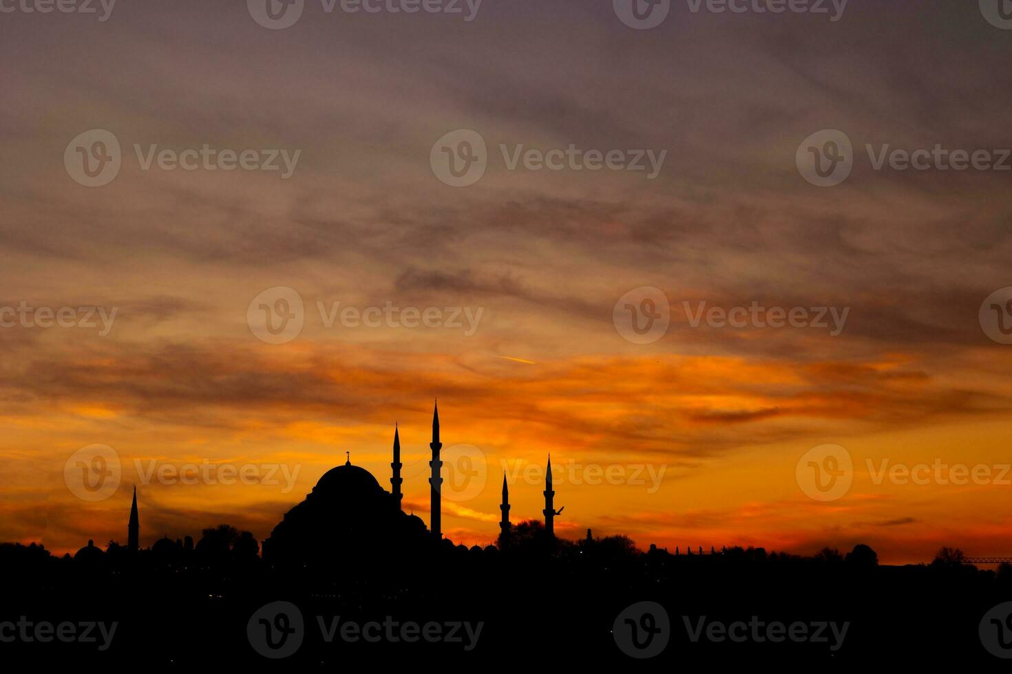 Istanbul silhouette. suleymaniye Mosque at sunset with dramatic clouds. photo