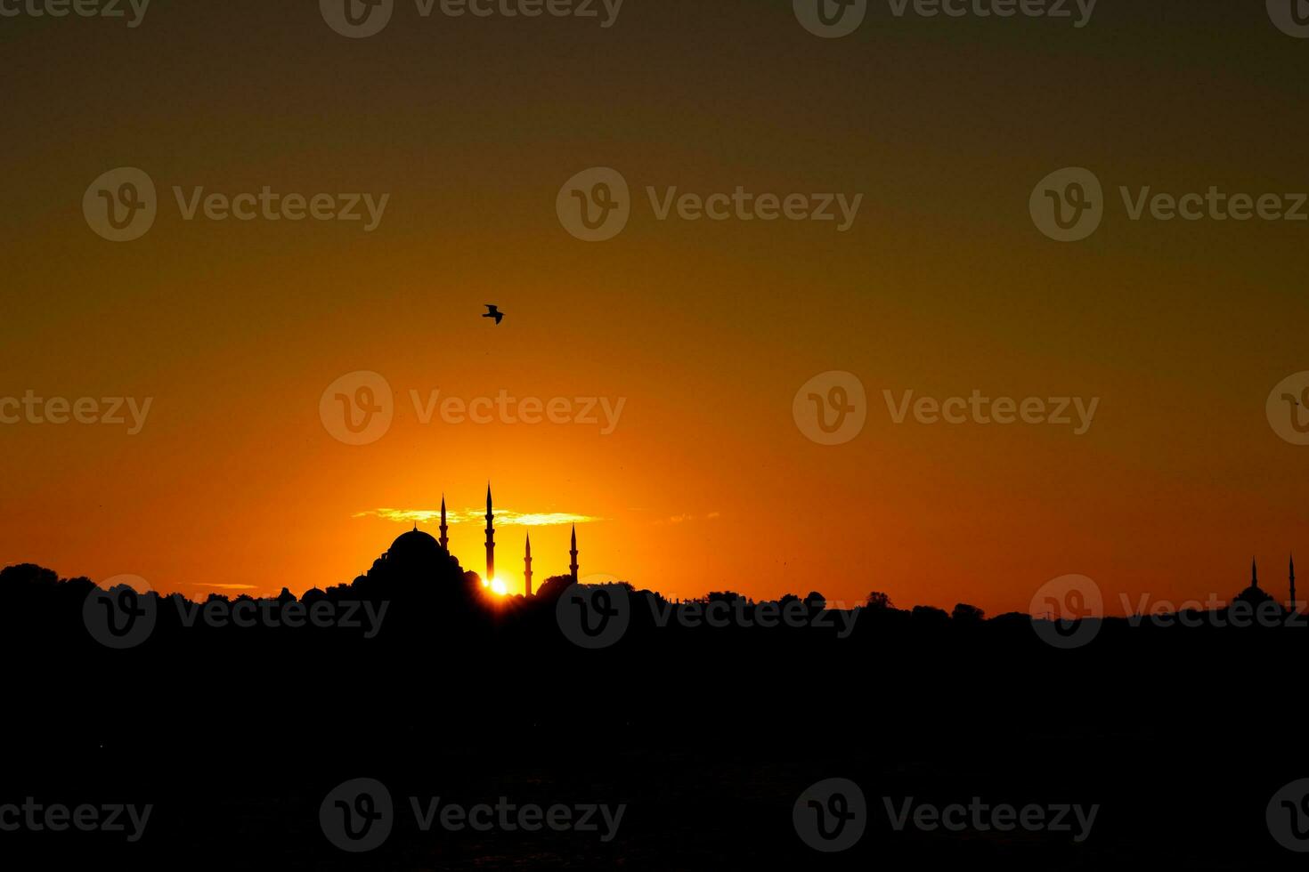 Istanbul silhouette at sunset. Clouds over the Suleymaniye Mosque and sun. photo